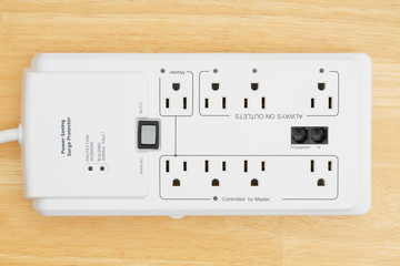 A power surge protector on wood