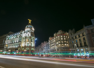 Fototapeta na wymiar Rays of traffic lights on Gran via street, main shopping street in Madrid at night. Spain, Europe