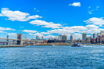 Fototapeta premium View of Brooklyn and Brooklyn Bridge from the East River Bikeway in Manhattan, New York.