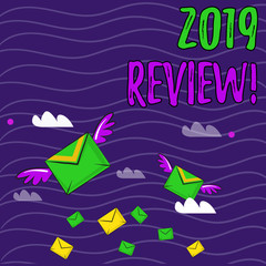 Text sign showing 2019 Review. Business photo showcasing remembering past year events main actions or good shows Many Colorful Airmail Flying Letter Envelopes and Two of Them with Wings