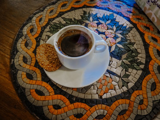 Turkish coffee with cardamon on a tradional mosaic table in Jordan. Handmade table.