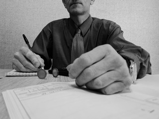 Business man works with financial documents. Businessman counts on a calculator.