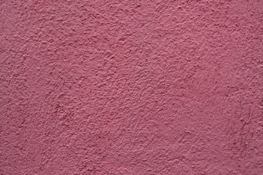 Dirty pink painted stucco wall. Background texture.
