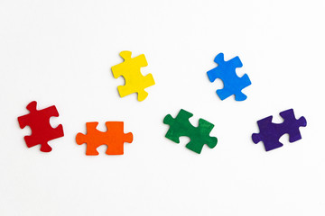 Fototapeta premium equality concept: LGBT pride flag built from a puzzle, among gray puzzles short focus, top view
