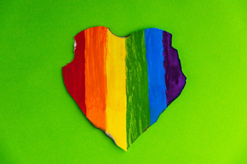 Concept - harassment of the freedom of the LGBT community: a burned and torn rainbow heart, short...