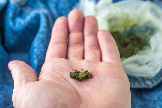 Tajik and Uzbek chewing tobacco called "nasvai", "nas", "nos" on the background of several packages with a similar tobacco product, a short focus