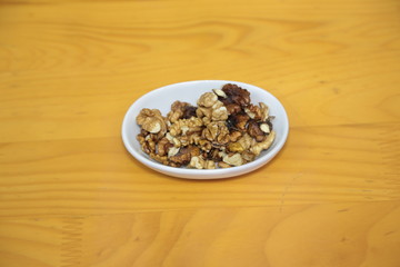 nuts in bowl on wooden background