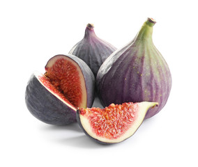 Whole and cut purple figs on white background