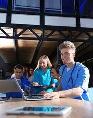 Group of smart medical students with gadgets in college