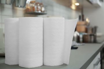 Rolls of paper towels on table in kitchen, closeup