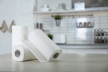 Rolls of paper towels on table in kitchen. Space for text