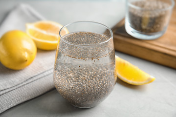 Composition with glass of water, chia seeds and lemon on table
