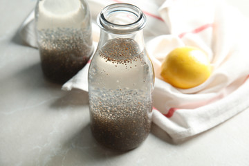 Composition with bottle of water and chia seeds on table