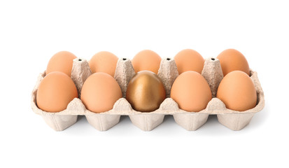 Eggs with golden one in carton on white background