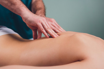 Young beautiful woman having massage in spa salon Physiotherapis.