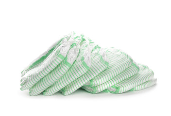 Pile of disposable diapers on white background. Baby accessories