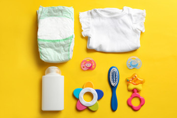 Flat lay composition with baby accessories on color background