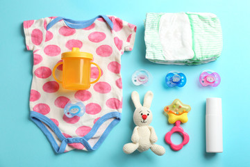 Flat lay composition with baby accessories on color background