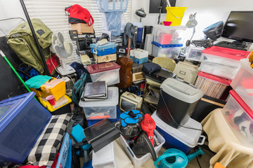Packed storage room filled with boxes, files, electronics, business equipment, sporting goods and...