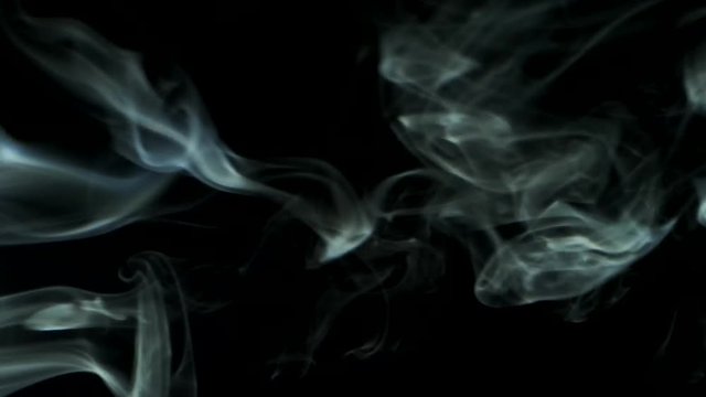 Vertical video screensaver - Trickle smoke rising graceful twists up on black background. Cigar smoke blowing from the left side. Great for editing, video without color correction and grading.