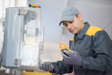 Mechanic fixing a machinery in an industrial environment
