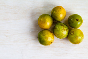 Spondias tuberosa (umbu) on textured background.