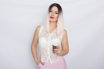 Blonde woman in white shirt with cup of coffee