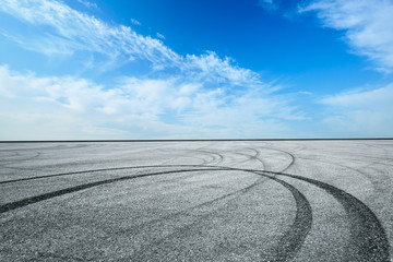 Empty asphalt race track ground and beautiful sky clouds
