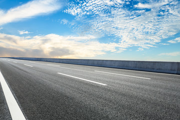 Empty asphalt road ground and blue sky with white clouds scene