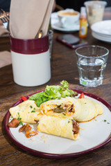 Italian sausage wrapped in scrambled egg