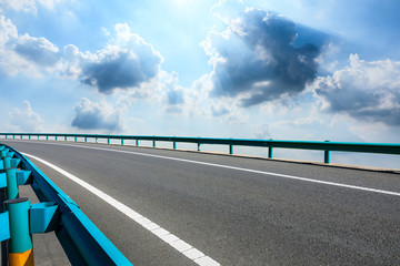 Empty asphalt road ground and blue sky with white clouds scene