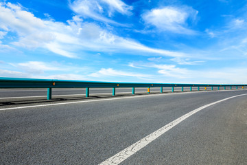 Empty asphalt road ground and blue sky with white clouds scene