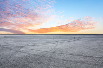 Asphalt race track ground and beautiful sky clouds at sunrise
