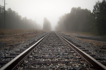 Fototapeta na wymiar Foggy rail road tracks