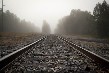 Fototapeta na wymiar Foggy rail road tracks