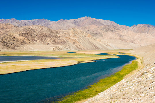 Pamir Mountains, Tajikistan - Aug 21 2018: Yashilkul Lake in Gorno-Badakhshan, Tajikistan. It is located in the World Heritage Site Tajik National Park (Mountains of the Pamirs).