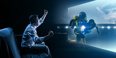 Young man playing american football video game