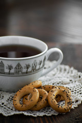 Bagels with cup of tea on a wooden board.