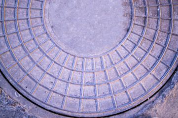 sewer metal iron hatch on the sidewalk. background, texture.
