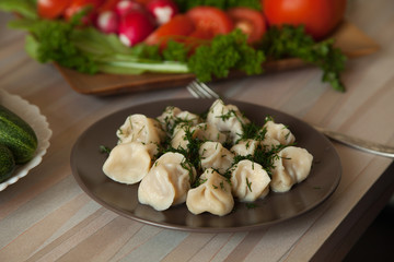 dumplings with herbs on a plate of vegetables