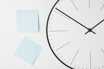 Round wall clock and blue stickers on white
