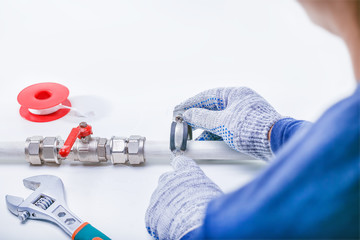 Plumber. Repair pipe with leak of water. Copy space.