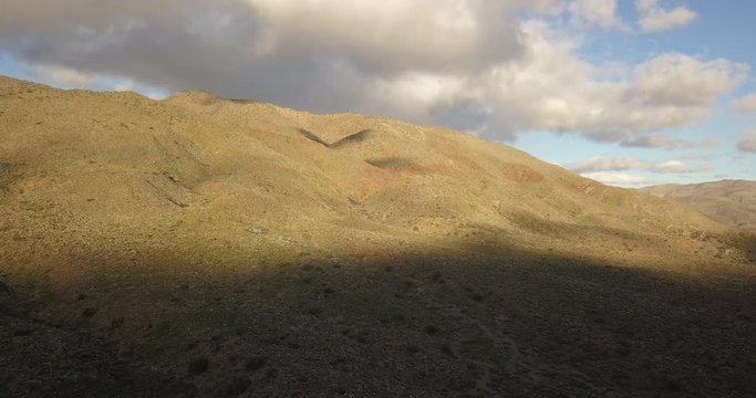 Shadows grow over mountain of California Anza Borrego State Park, Wide Aerial View