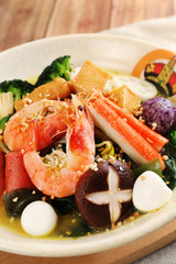 Shrimp and dry mushrooms spicy hot pot in a white ceramic dish