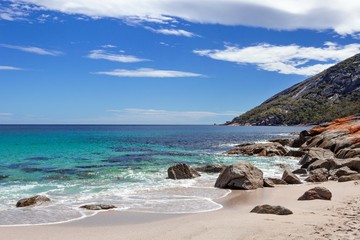 The Freycinet peninsula is a place of vibrant color - orange lichen, turquoise water and white rimmed waves.