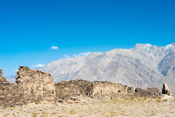 Fototapeta na wymiar Pamir Mountains, Tajikistan - Aug 22 2018: Ruins of Yamchun Fort in the Wakhan Valley in Gorno-Badakhshan, Tajikistan. It is located in the Tajikistan and Afghanistan border.