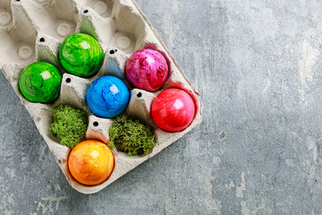 Paper box with Easter eggs on grey, stone background