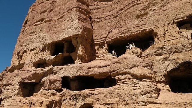 This world heritage site is located in the Bamyan Valley of Afghanistan. Part of this site was destroyed in 2001 by the Taliban. Wide shot from exterior.