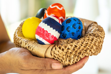 Hands holding modern painted easter eggs. Selective focus.