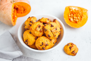 Pumpkin cookies with chocolate chips made from cake mix in a white ceramic bowl.